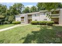 Tan colored apartment building with a walkway and landscaping at 1602 Eagles Pl # J103, Rock Hill, SC 29732