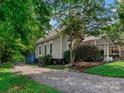 Quaint home with gray siding and a gravel driveway at 510 5Th St, Spencer, NC 28159