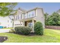 Two-story house with a neutral exterior and landscaped yard at 127 Tranquil Ct # 18A, Locust, NC 28097