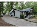 Home's side view showcasing a driveway and detached shed at 310 Chaney St, Wingate, NC 28174