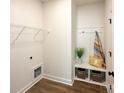 Bright laundry room with built-in bench, shelving, and window at 604 Wyoming Dr, Concord, NC 28027