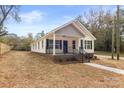 Newly built home with gray siding, brick accents, and a front porch at 57 Pickney St, York, SC 29745