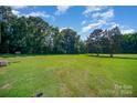 Large grassy backyard with mature trees at 1418 Oakwood Ave, Kannapolis, NC 28081
