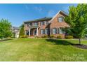 Two-story brick home with a lush green lawn at 2073 Hambridge Ave, Kannapolis, NC 28081