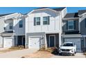 Two-story townhome with gray and white siding, white garage door, and landscaping at 3820 Shider Ln, Kannapolis, NC 28081