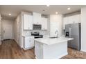 Modern kitchen with white cabinets, stainless steel appliances, and quartz countertops at 3820 Shider Ln, Kannapolis, NC 28081