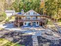 Two-story lake house with a large deck and stone patio with fire pit at 124 La Agua Ln, Troutman, NC 28166