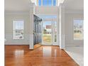 Bright and spacious foyer with hardwood floors and a view of the front yard at 235 Coralstone Dr, Fort Mill, SC 29708