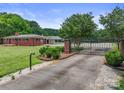 Brick house with a gated entrance and landscaping at 6620 Old Concord Rd, Salisbury, NC 28146