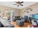 Relaxing living room with gray sectional sofa, ottoman, hardwood floors, and fish tank at 1000 Creekside Dr, Lincolnton, NC 28092