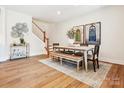Bright dining room with hardwood floors, a farmhouse table, and stylish wall art at 135 Armstrong Rd, Belmont, NC 28012