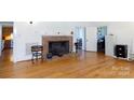 Living room with hardwood floors, brick fireplace and built-ins at 243 Love St, McConnells, SC 29726