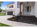 Two story home with light blue door and dark brick steps leading to the entrance at 1529 Beckwith Pl, Charlotte, NC 28205