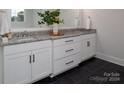 Elegant bathroom with granite countertops, double sinks, and dark tile floor at 00 Rivendell Rd # 7, Denver, NC 28037