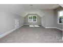 Spacious bonus room with neutral carpet and two windows at 00 Rivendell Rd # 7, Denver, NC 28037