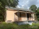 Older fixer-upper home with a porch and needs significant renovations at 303 Ray St, Lancaster, SC 29720