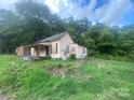 Older fixer-upper home with a porch and needs significant renovations at 303 Ray St, Lancaster, SC 29720