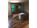 Living room with wood-paneled walls and wood-look flooring at 661 Small Rd, Biscoe, NC 27209