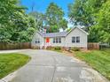 Tan house with red door and curved driveway at 919 Edgemont Ave, Belmont, NC 28012