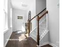 Bright entryway with hardwood floors, staircase, and ample natural light at 10611 Audubon Ridge Dr # 26, Cornelius, NC 28031