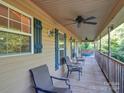 Relaxing front porch with ceiling fan and comfortable seating at 168 Marlow Woods Ln, Statesville, NC 28625