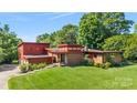 Mid-century modern home with brick and red siding, steps leading to entry at 640 Davie Ave, Statesville, NC 28677