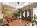 Spacious entry with tile floor, decorative plants, and stained-glass door at 640 Davie Ave, Statesville, NC 28677