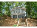 Lakefront home exterior with a screened porch and stairs leading to the lake at 192 Clearview Point Dr, Mount Gilead, NC 27306