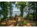 Wooden walkway to lakefront with benches and scenic lake view at 192 Clearview Point Dr, Mount Gilead, NC 27306