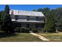 Rustic two-story farmhouse with a large front yard and stone walkway at 655 Lippard Rd, Salisbury, NC 28146