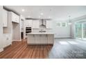 Modern kitchen with white cabinets, island, and stainless steel appliances at 2024 Cedar Falls Dr # 9, Waxhaw, NC 28173