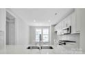 Modern kitchen featuring white cabinets and quartz countertops at 9837 Jubilee Ct, Charlotte, NC 28215