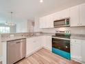 Modern kitchen with white cabinets and granite countertops at 253 Franklin Nw Ave, Concord, NC 28025