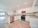Modern kitchen with white cabinets and granite countertops at 253 Franklin Nw Ave, Concord, NC 28025
