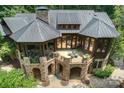 Luxury home with large stone patio and wrap around balcony at 17625 Grasshopper Ln, Charlotte, NC 28278