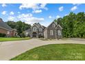 Two-story home with stone and brick exterior, landscaping, and driveway at 531 Coman Ln, Kings Mountain, NC 28086