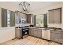 Renovated kitchen features gray cabinets, granite countertops, and stainless steel appliances at 1228 N Main St, Salisbury, NC 28144
