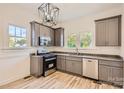 Renovated kitchen features gray cabinets, granite countertops, and stainless steel appliances at 1228 N Main St, Salisbury, NC 28144