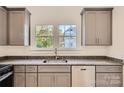 Renovated kitchen features gray cabinets, granite countertops, and stainless steel appliances at 1228 N Main St, Salisbury, NC 28144