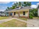 Inviting yellow house with a front porch and landscaped yard at 430 Dave Lyle Blvd, Rock Hill, SC 29730