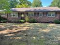 Brick ranch house with a landscaped yard at 307 Eddleman Rd, Kannapolis, NC 28083