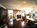 Cozy living room with brick fireplace and hardwood floors at 5419 Stevens Mill Rd, Matthews, NC 28104