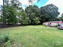 Mobile home on a large lot with mature trees at 5401 Stevens Mill Rd, Matthews, NC 28104