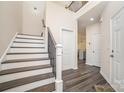 Modern staircase with dark wood treads and black metal railing at 2005 Germany Dr, Dallas, NC 28034
