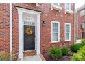 Brick townhouse with front door and landscaping at 2220 Camalier Ln, Charlotte, NC 28273