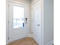 White front door with glass panel and keyless entry at 1530 Levy Way, Charlotte, NC 28205