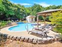 Relaxing pool and spa area with pergola and lounge chairs at 8534 Headford Rd, Charlotte, NC 28277