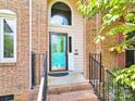 Brick front entrance with teal door and wrought iron railings at 8534 Headford Rd, Charlotte, NC 28277
