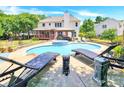 Luxury pool and spa with lounge chairs and backyard view at 8534 Headford Rd, Charlotte, NC 28277