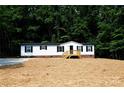 White single-wide manufactured home with black shutters and a wooden deck at 2574 Orchard Rd, Smyrna, SC 29743